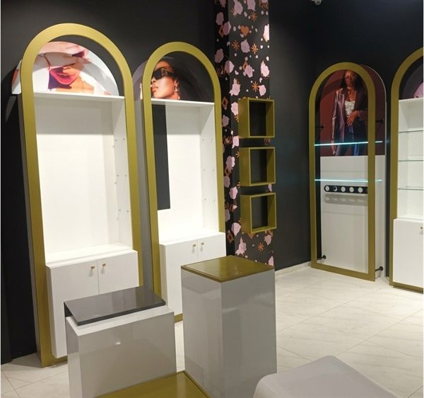 Boutique wall displays with gold-framed arches, display plinths, and feature shelving &mdash; Wito Projects Johannesburg
