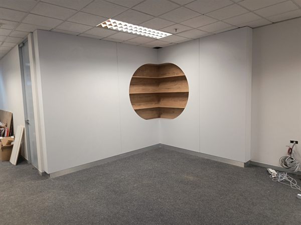 Office drywall partition with circular timber display niche &mdash; Wito Projects Johannesburg