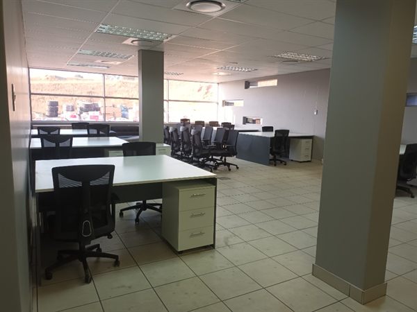 Open-plan office with desk clusters, task chairs, and ceiling grid &mdash; Wito Projects Johannesburg