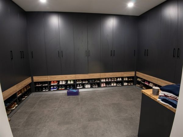 Walk-in wardrobe with floor-to-ceiling cupboards and open shoe bays &mdash; Wito Projects Johannesburg